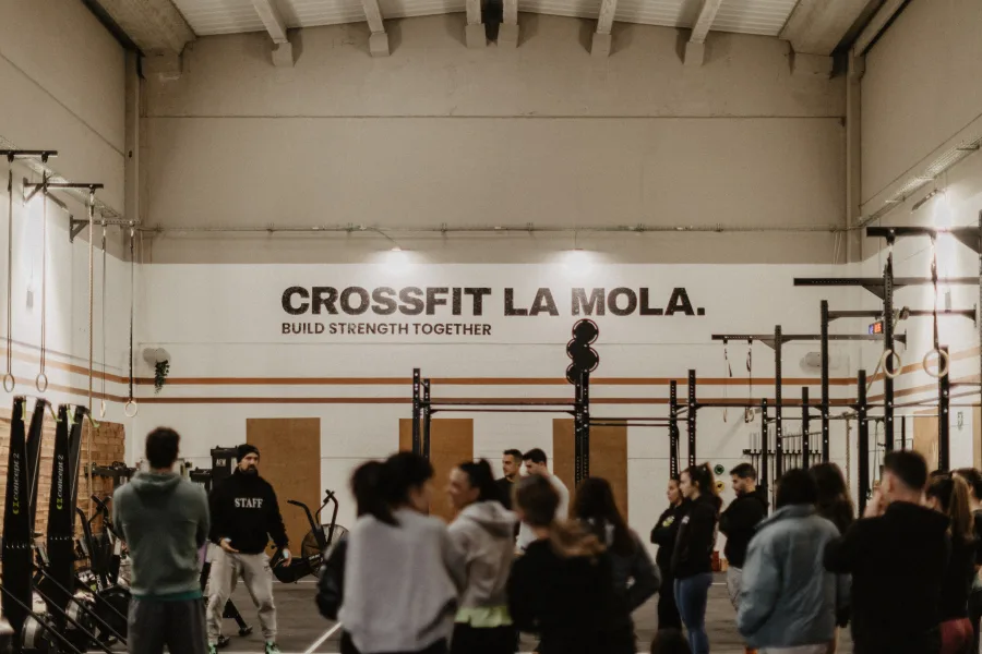 WOD class at CrossFit La Mola with group of athletes and coach explaining the workout