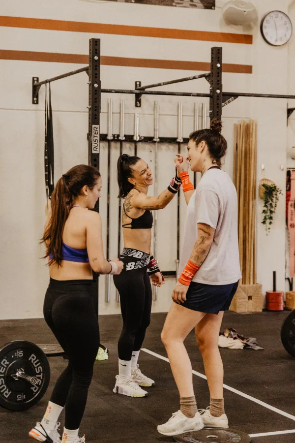 Two athletes smiling while training on Echo Bikes