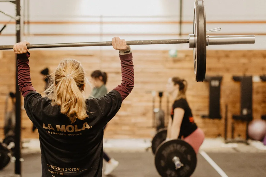 Group of athletes cheering on a teammate during the WOD