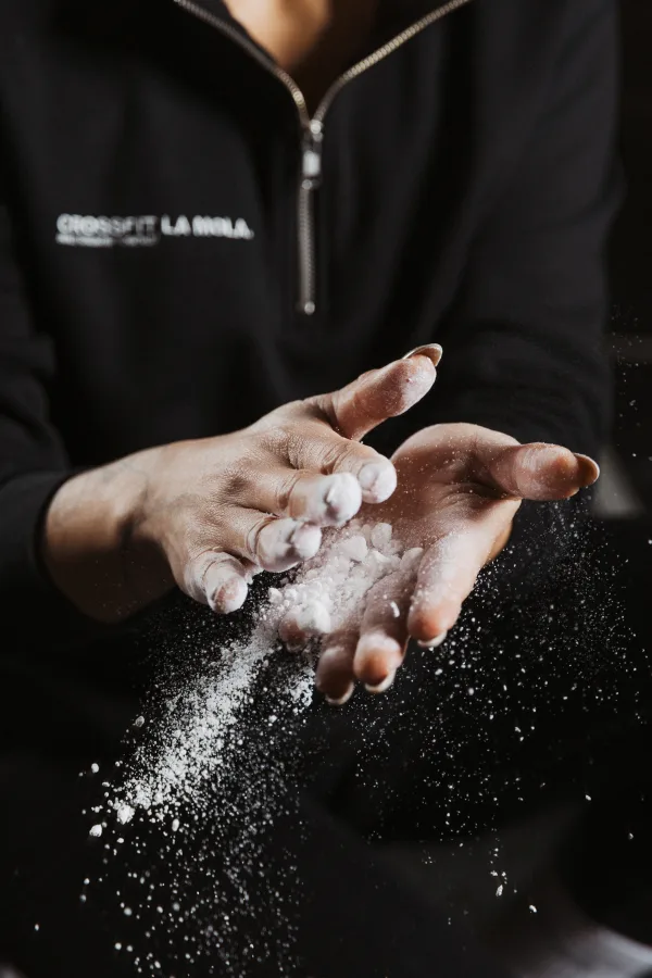 Athlete's chalked hand preparing for a lift